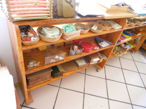 Shelves full of different materials, the Montessori learning material is designed to be very attractive