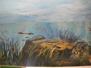 Mural of a prehistoric ocean on the ceiling of a Montessori school's entrance