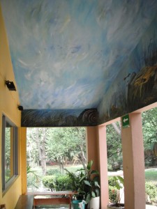 View from the school's entrance to the garden, you can see part of the mural on the ceiling.