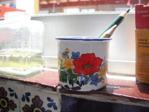This is the other mug I like looking at, it's really tiny and has a big red flower that looks like a poppy and many yellow flowers and tiny blue flowers